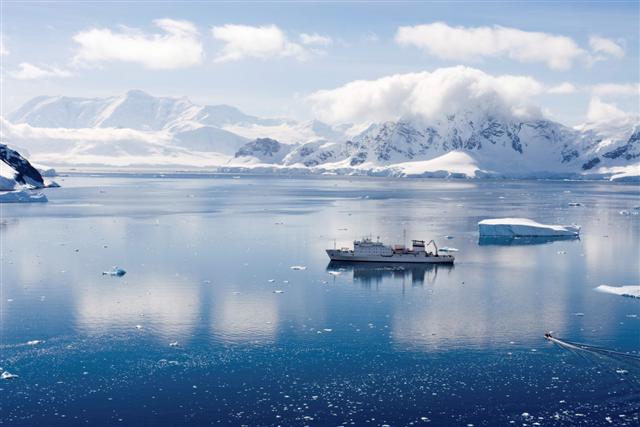 small boat sailing in arctic waters